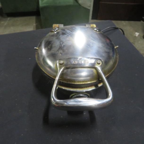 All Clad waffle maker, model 6071, stainless steel, 800 watt, 120 volt, in used condition with visible surface wear.