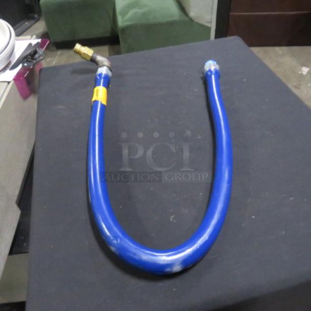 Blue gas line, new condition, with brass connector and visible label.