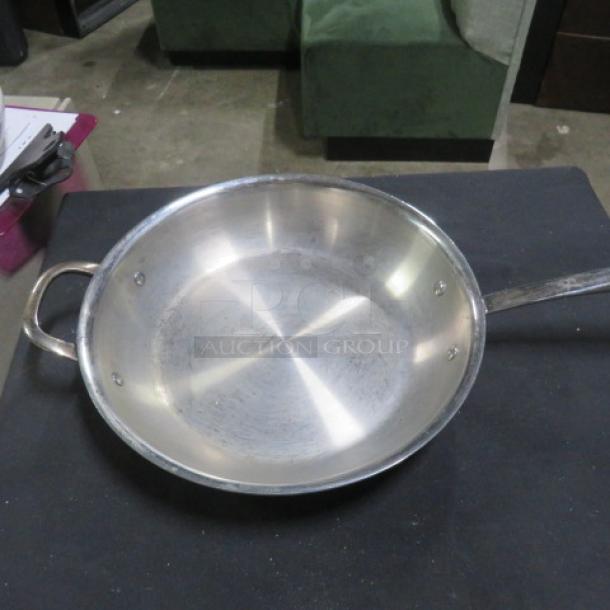 Williams Sonoma 12" stainless steel Thermo Clad fry pan with lid. Gently used, visible surface wear. Retail price $229.95.