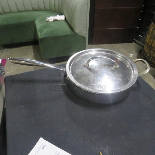 Williams Sonoma stainless steel 4.5-quart sauté pan with lid, featuring long handle, side handle, and polished finish.