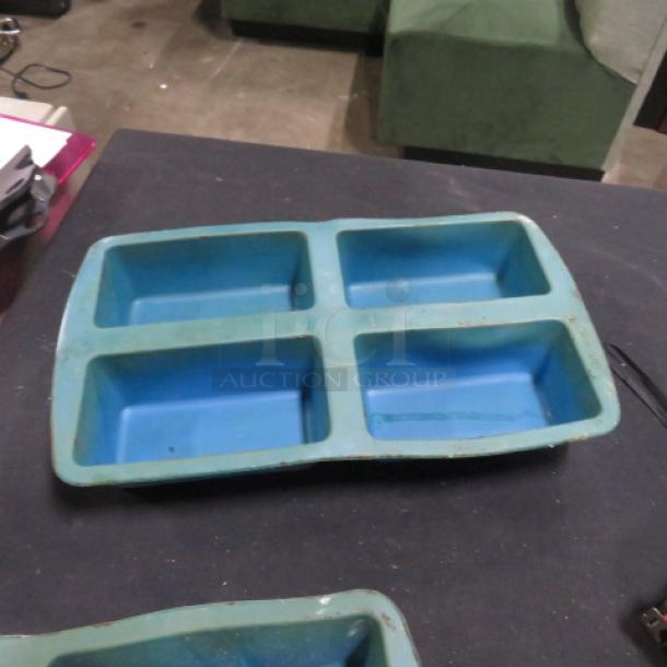 Wilton Mini Loaf Silicone Mold with four slots, blue, gently used, 6XBID. Ideal for baking mini loaves.