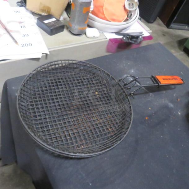 Round BBQ Master fry basket with non-stick mesh, wooden handle, and visible branding. Used condition.