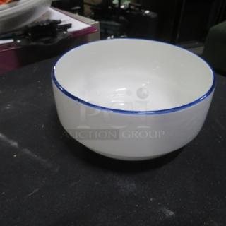 White 6-inch ceramic bowl with blue rim, excellent condition, displayed on table, item code 11XBID.