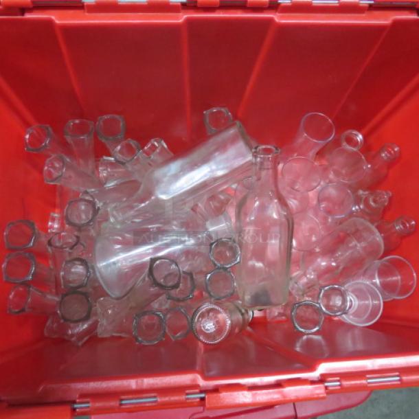 Assorted glass tabletop vases and bottles, various shapes and sizes, in a red container. Good condition.