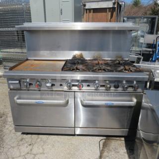 Cook Rite natural gas range with 6 burners, 24" griddle, double ovens, 3 racks. Stainless steel over shelf. Dimensions 60x32x57.