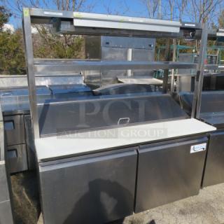 Avantco 2-door refrigerated prep table with cutting board, stainless overshelves, ticket rail, and Servit food warmer, on casters. Model 178SSPT60-HC.
