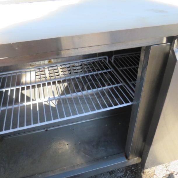 Avantco 2-door refrigerated prep table, model 178SSPT60-HC, with stainless steel shelves and cutting board, shown open.