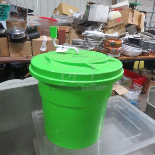 Lime green salad spinner, manual crank, large capacity, plastic material, used condition, visible wear.