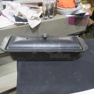 Le Creuset 2 qt terrine cast iron baker with lid, black. Good condition, minor wear. Features classic knob handle. Valued at $225.