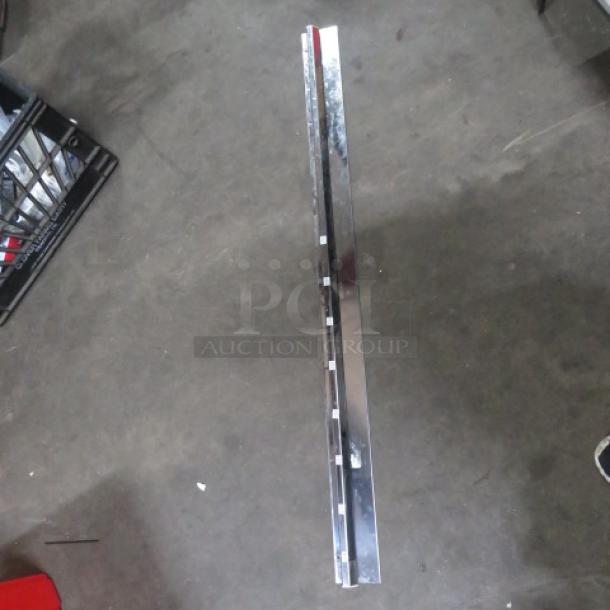 44-inch stainless steel ticket rail in good condition, showing reflective surface and slots for holding tickets.