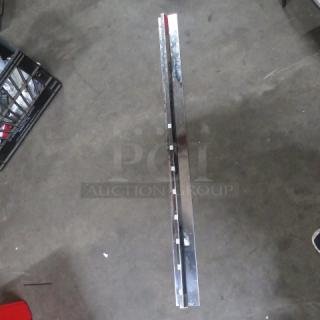 44-inch stainless steel ticket rail in good condition, showing reflective surface and slots for holding tickets.