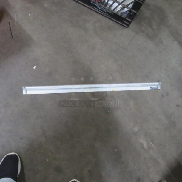 San Jamar 36-inch ticket rail, metal construction, good condition, with visible brand label on the right end.