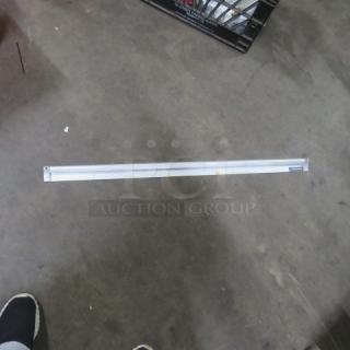 San Jamar 36-inch ticket rail, metal construction, good condition, with visible brand label on the right end.