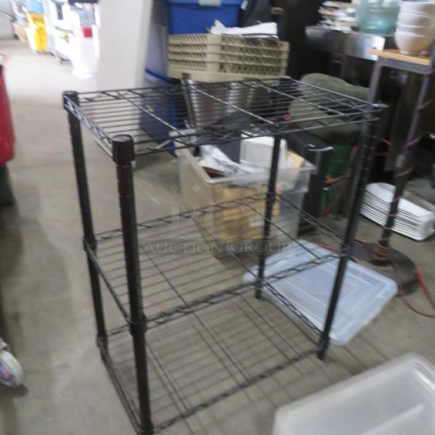 Black Metro shelf with 3 wire shelves, dimensions 24x14x30 inches. Sturdy, good condition, ideal for storage.