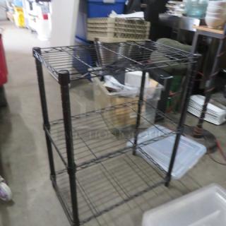 Black Metro shelf with 3 wire shelves, dimensions 24x14x30 inches. Sturdy, good condition, ideal for storage.