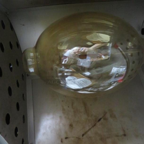 Vintage Capitol Theater Equipment Co. warmer, metal housing, aged patina, visible bulb, fair condition, no visible labels.