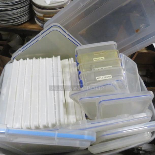 A collection of plasticware containers with blue lids, various sizes. Labels include "Turbinado" and "Apple Pectin". Used condition.