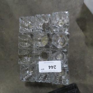 Heavy cut glass candle holder, 12 pieces. Clear glass, square shape, pristine condition, stacked for display.