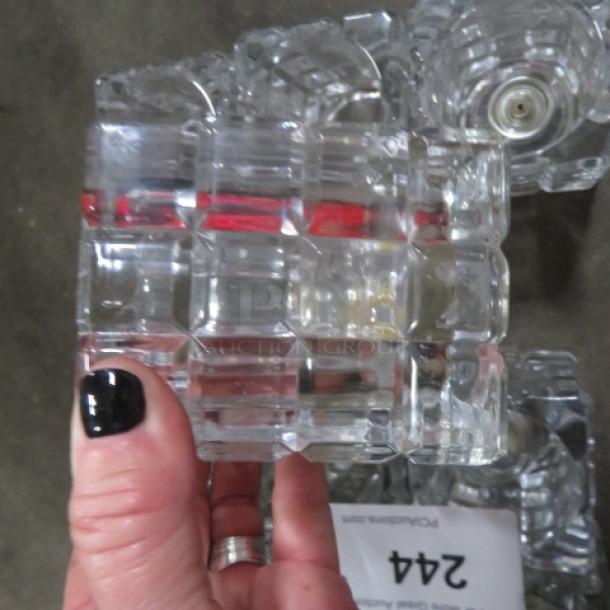 Heavy cut glass candle holder with geometric design. Features clear, textured glass. Appears in good condition. Item 12XBID.