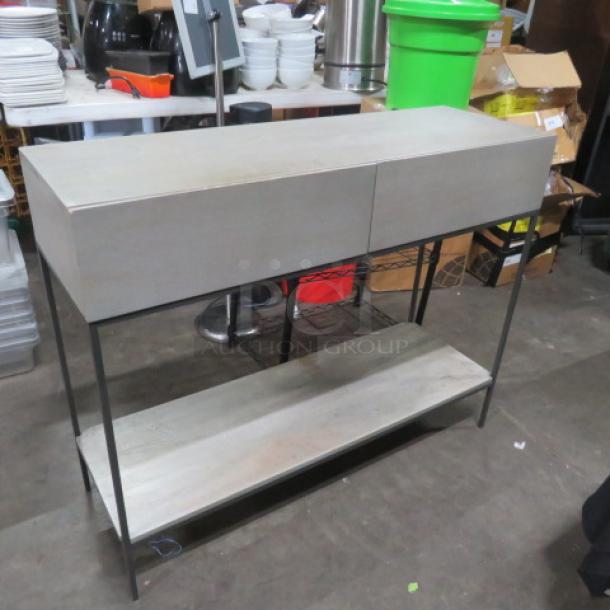Metal wooden table with two drawers, one wooden under-shelf, in good condition. Dimensions: 42x14x34 inches.