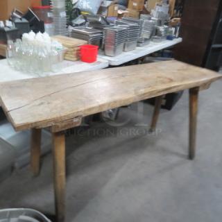 Unique slab wood table with wooden legs, measuring 66.5x22x33 inches. Rustic appearance, suitable for various decors.