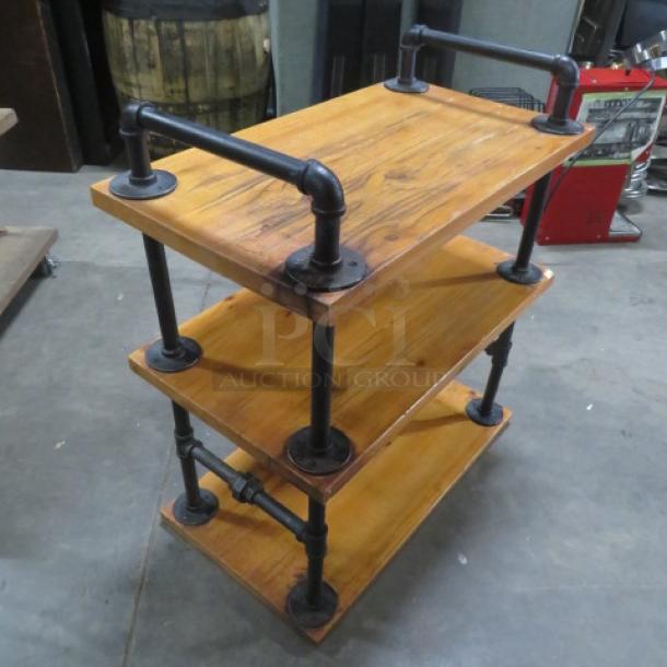 Industrial-style wooden shelving unit with three shelves, 27.5x16x31 inches, black metal pipe supports, minimalist design.