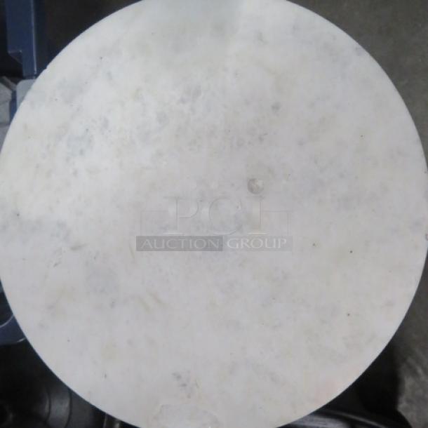 Small round table with marble top and metal base, 10x22.5 inches. Marble is chipped.