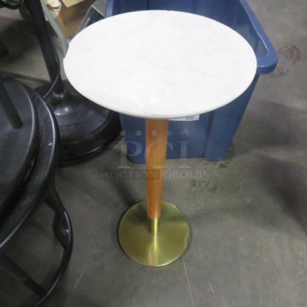 Small round table with marble top and metal base, 10x22.5 inches. Marble is chipped.