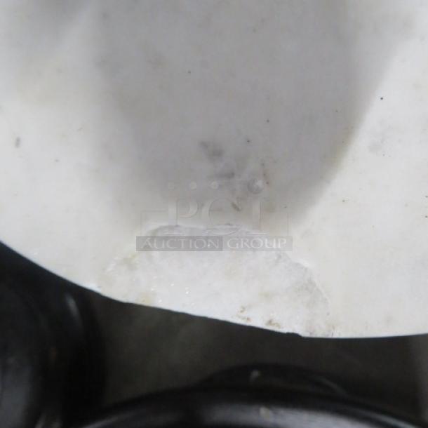 Small round table, marble top with a visible chip, metal base, dimensions 10x22.5 inches.