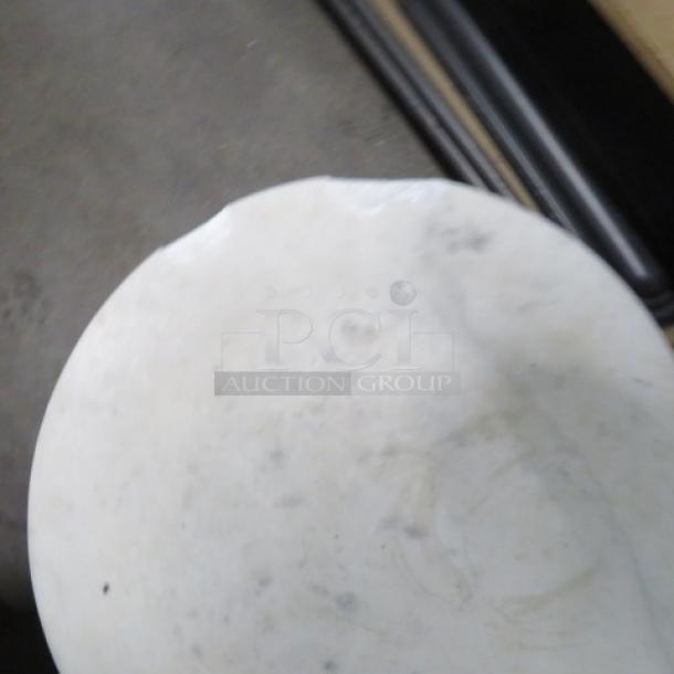 Small round table with marble top and metal base; marble is chipped. Dimensions: 10x22.5 inches.