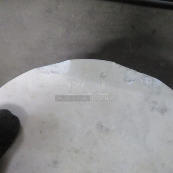 Small round marble-top table with metal base, 10x22.5 inches. Marble is chipped, visible in image.
