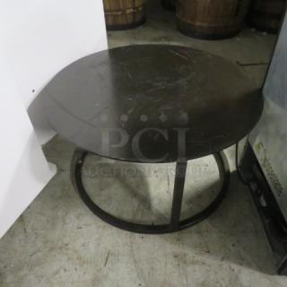 Black metal round table, very heavy, 30x16 inches. Features a minimalist design with a sturdy build.