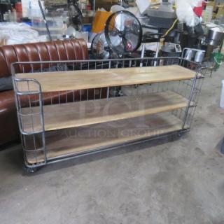 Wooden and metal shelving unit with three shelves on casters, measuring 72x17x34. Sturdy design, good condition.