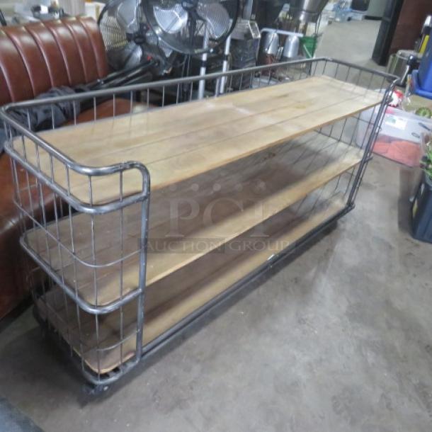 Wooden and metal shelving unit, 3 shelves, on casters; dimensions 72"x17"x34". Industrial design with wire sides.