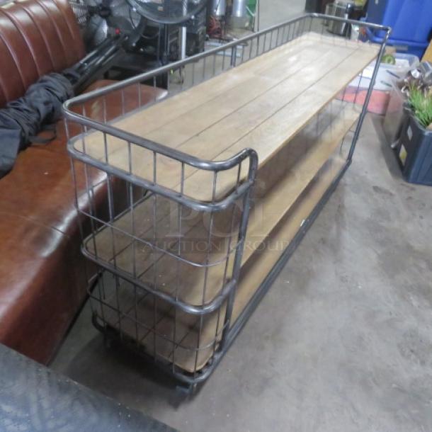 Wooden and metal shelving unit on casters, featuring three shelves. Dimensions 72x17x34 inches. Sturdy construction.
