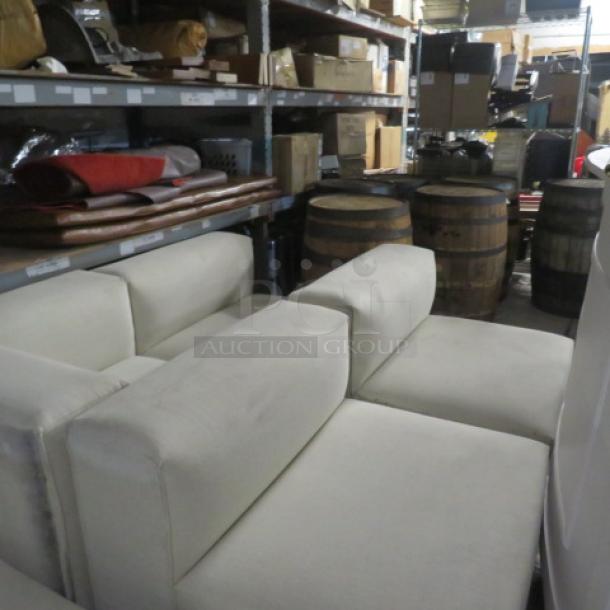 White 6-piece overstuffed sectional couch, very large and heavy sections, displayed in storage setting.