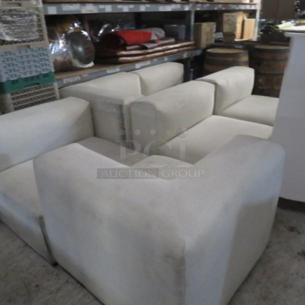 White overstuffed 6-piece sectional couch, very heavy and large sections. Some wear visible, ideal for spacious areas.