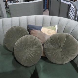 Assorted pillows, including three round tufted green velvet pillows and one multicolored square pillow. Excellent condition.