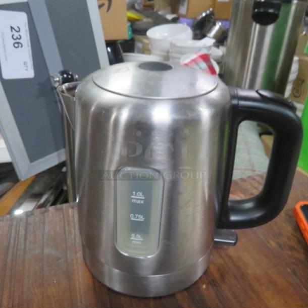 Stainless steel coffee/tea pot with black handle, 1.0L capacity indicator on the side, good condition.
