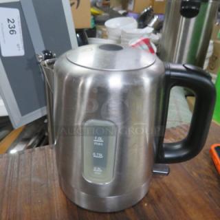 Stainless steel coffee/tea pot with black handle, 1.0L capacity indicator on the side, good condition.