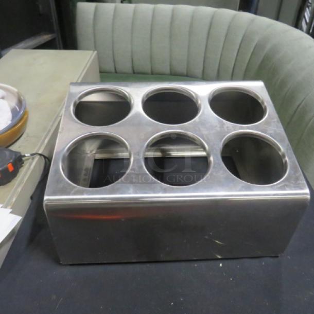 Stainless steel flatware holder with six circular slots, excellent condition.