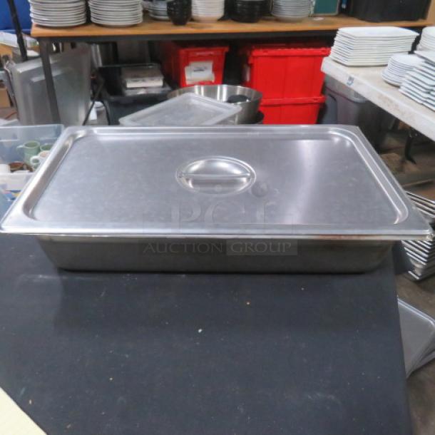 Full-size 4-inch deep stainless steel hotel pan with lid. Used condition. Ideal for food service applications.