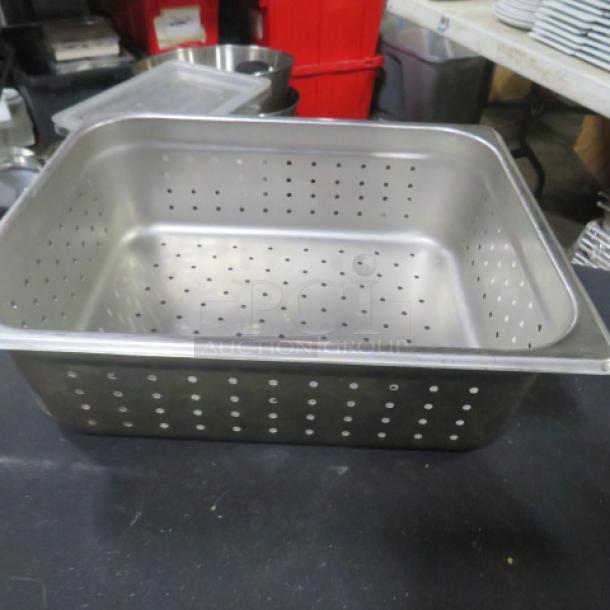 One half-size 4-inch deep perforated hotel pan, stainless steel, used, with visible perforations for drainage.