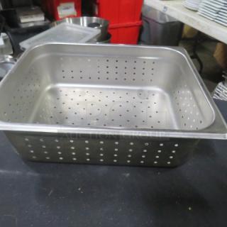 One half-size 4-inch deep perforated hotel pan, stainless steel, used, with visible perforations for drainage.