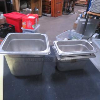Assorted stainless steel hotel pans in varying sizes, used condition, suitable for commercial kitchen applications.