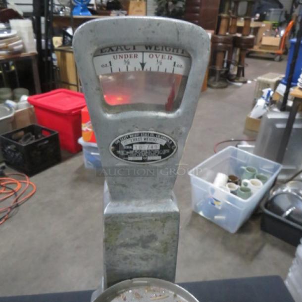 Vintage bakers scale with "Exact Weight" gauge, metal body, and manufacturer label. Used condition.