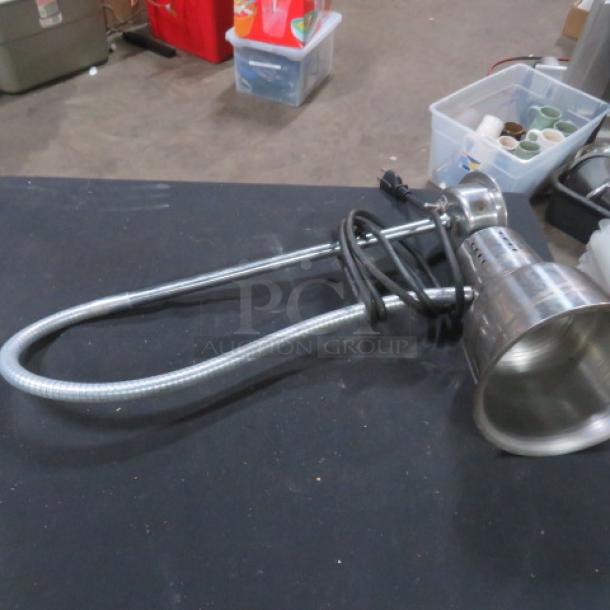 Adjustable stainless steel warmer light, used condition, flexible neck, with power cord. Ideal for commercial kitchens.