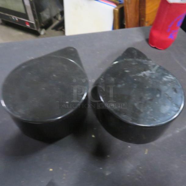 Pair of black Margarita Salter items, slightly worn, with round tops and spouts. Appears used.