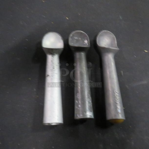 Three aluminum scoops displayed on a dark surface. Slight wear visible, indicating used condition. Model 3XBID.
