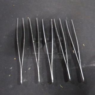 Set of six stainless steel bar tongs. Model 5XBID. Used condition, suitable for bar or culinary use.